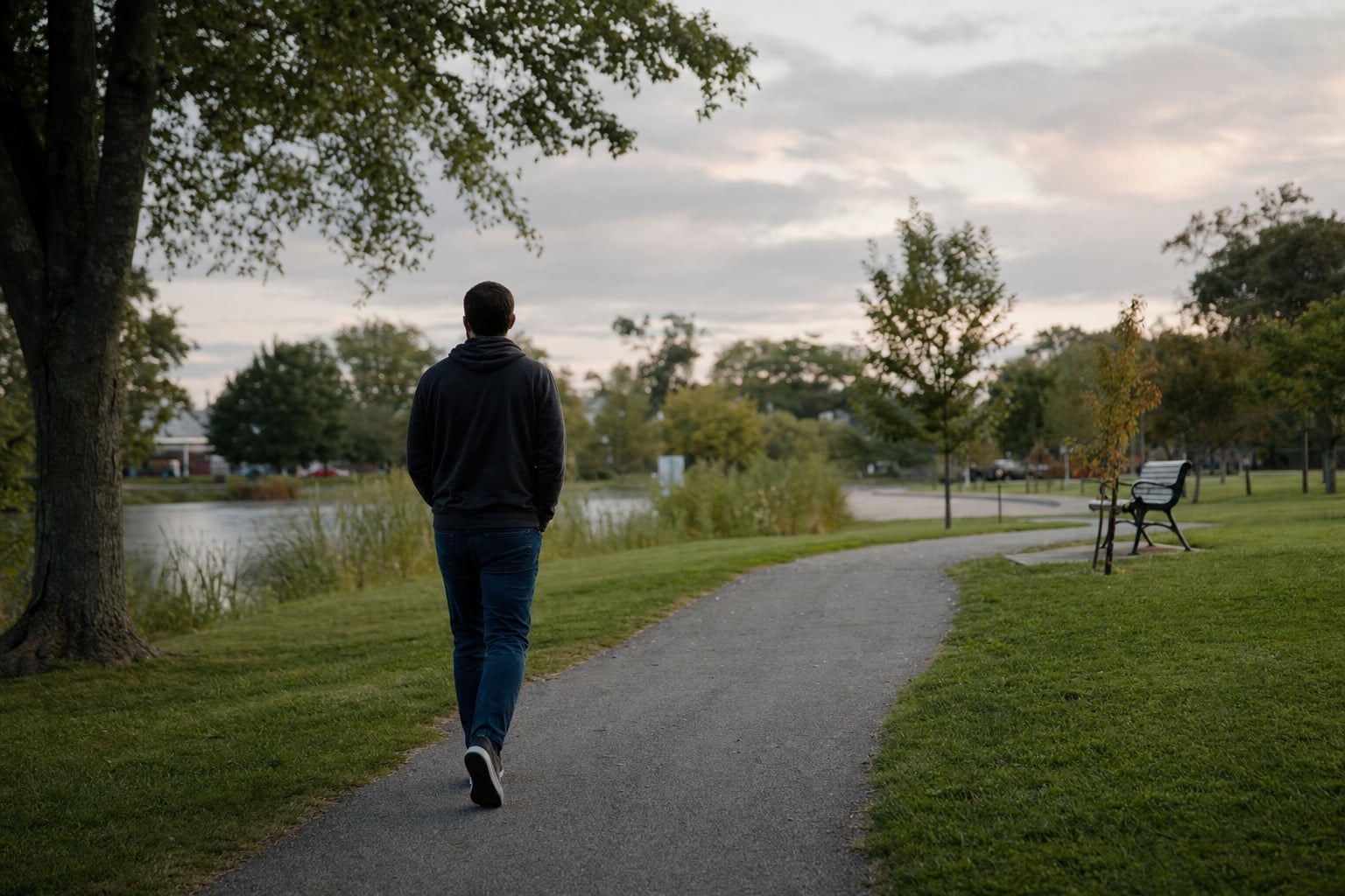 A person taking a quiet walk through a neighborhood park