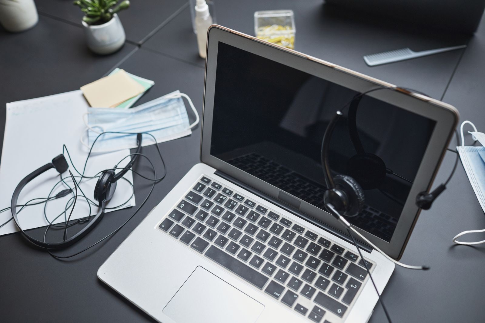 Laptop and headset ready on a desk before an online event