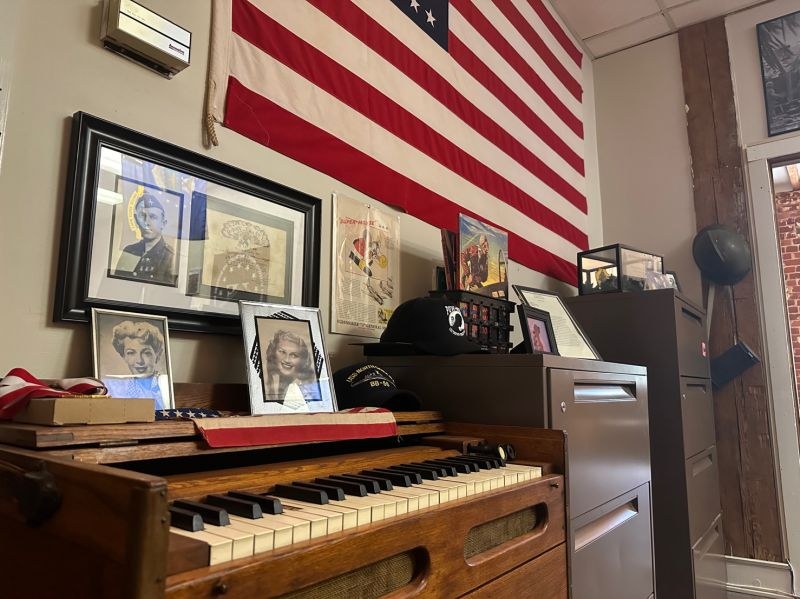 Historic piano and family photographs inside History Flight headquarters