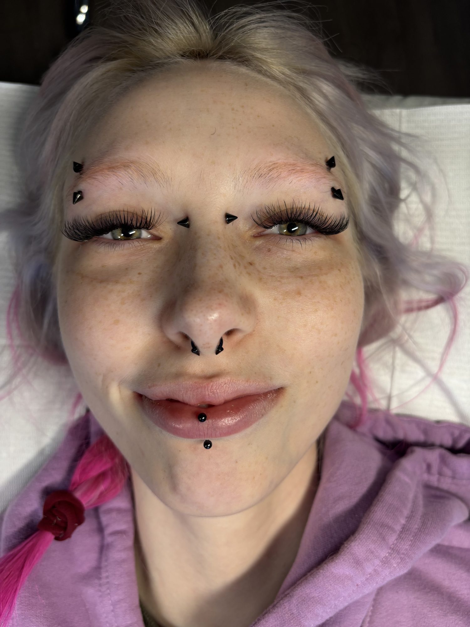 Full lash extensions on a client with pink and silver hair