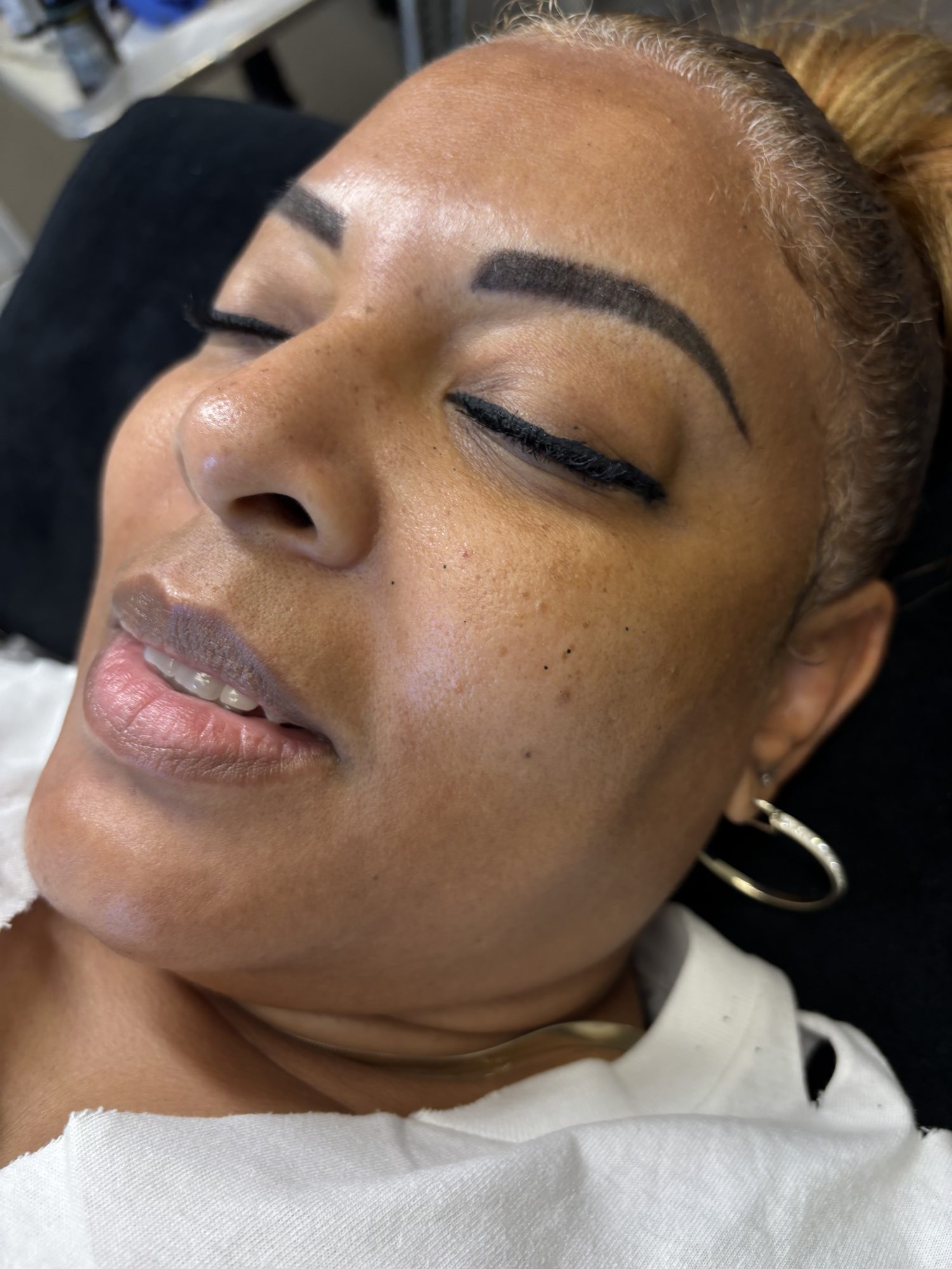 Defined permanent makeup brows viewed at an angle