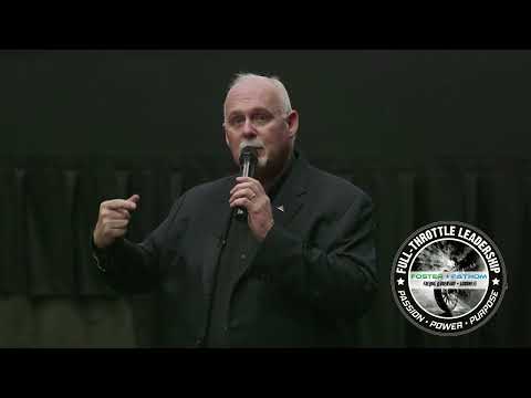 Steven Foster speaking on stage with a microphone