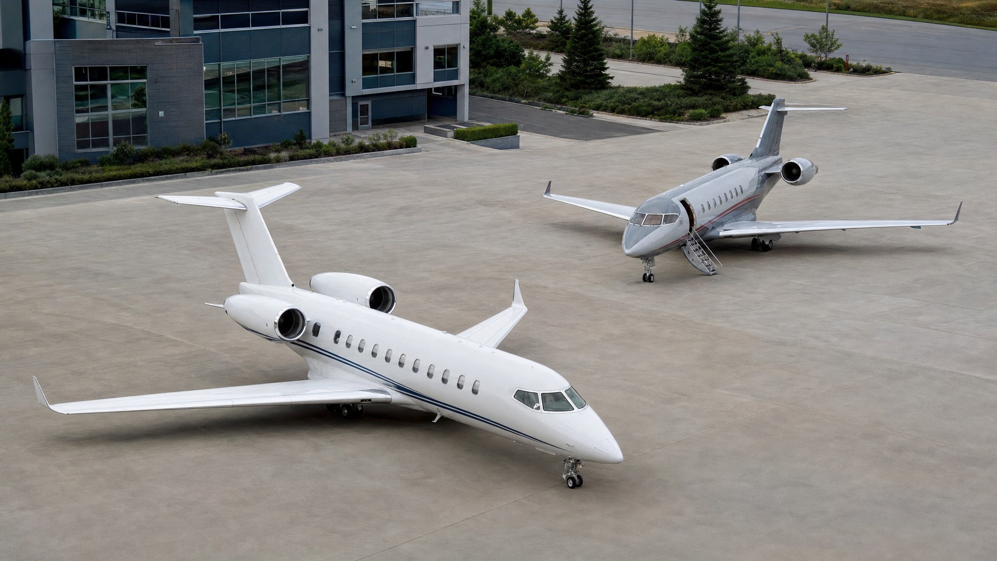 Two comparable business jets parked apart on a private aviation ramp