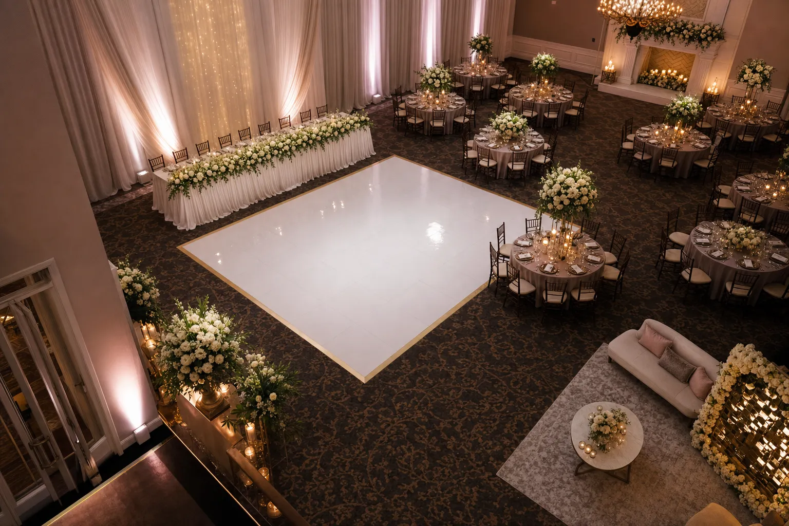 Elevated view of a wedding reception arranged around a white dance floor with tables and clear paths