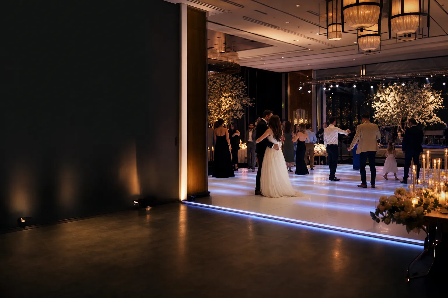 Wedding guests dancing on a glowing white LED dance floor in a Dallas ballroom