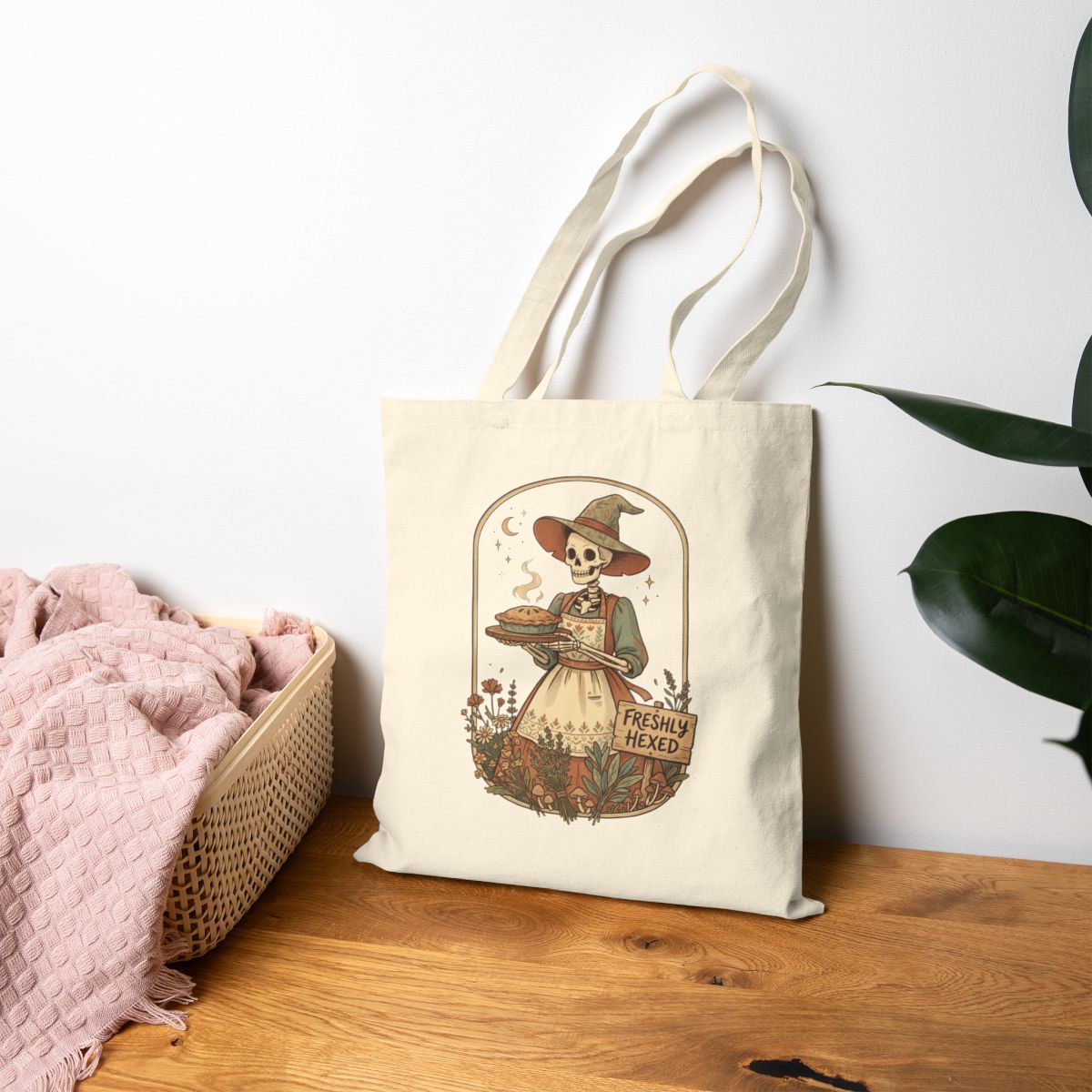 Witchy skeleton baker tote with moons, herbs, and a cottagecore illustration