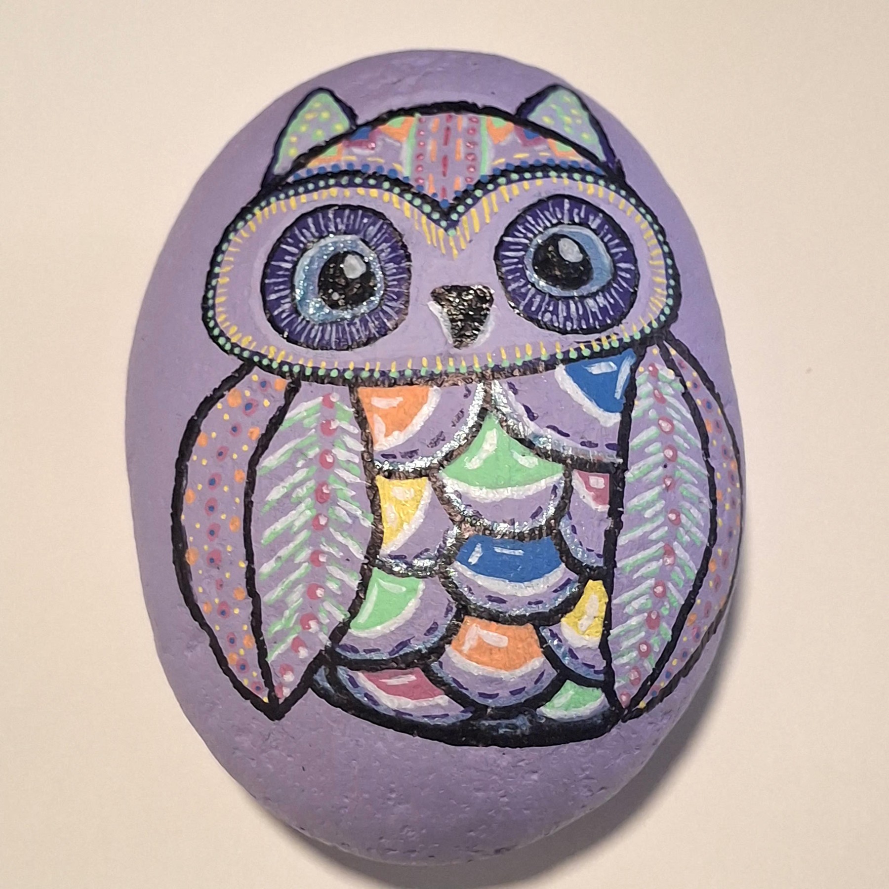 Purple owl stone with colorful hand-painted feather patterns by Robin