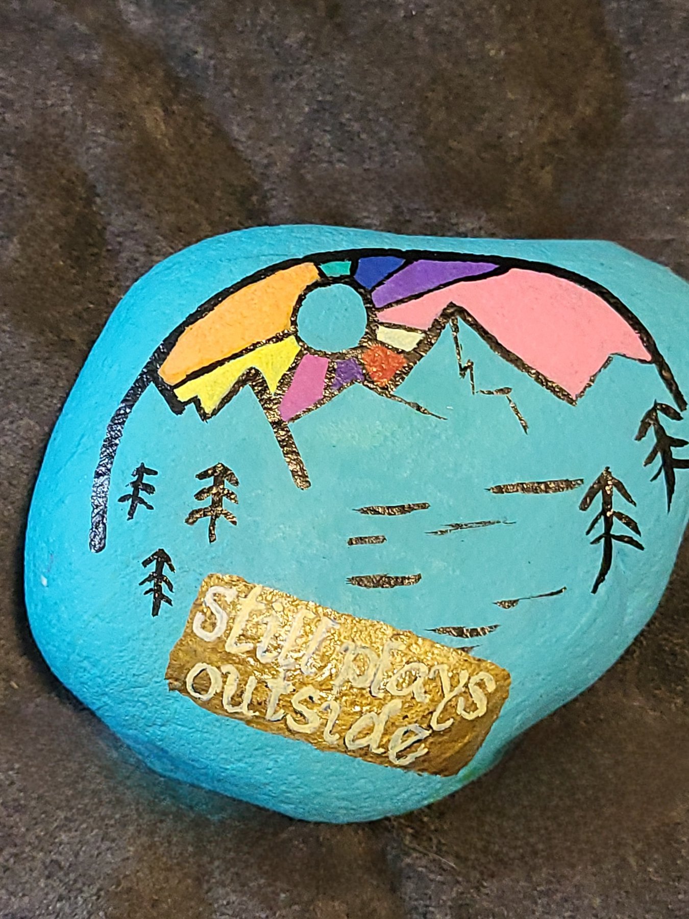 Mountain scene painted rock with Still plays outside lettering
