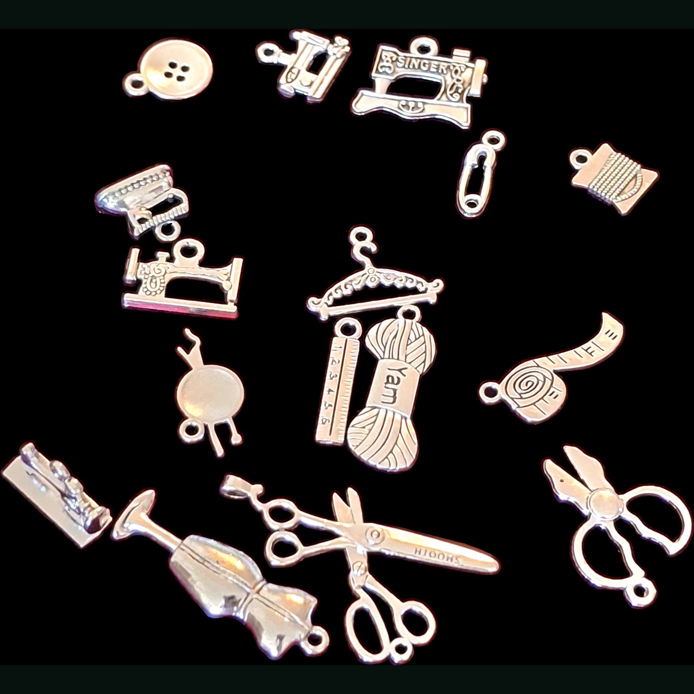 Selection of sewing-themed charms including scissors, sewing machines, thread, and buttons