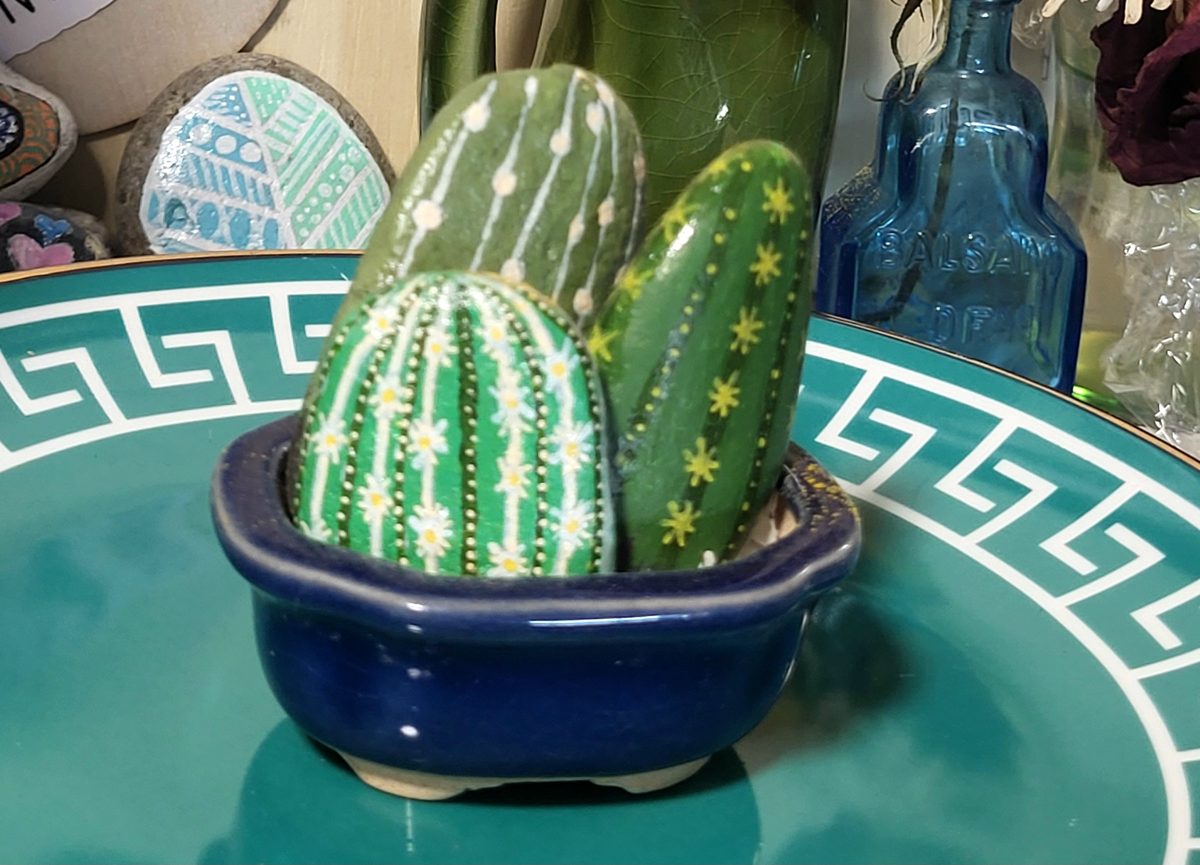 Three green hand-painted cactus stones arranged upright in the included blue clay pot