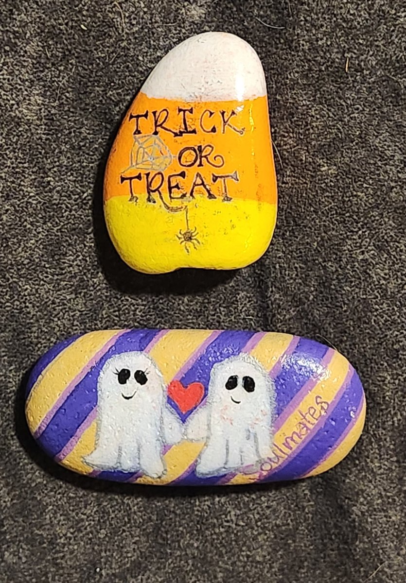 Candy-corn-colored Trick or Treat rock and a purple-striped rock with two smiling ghosts