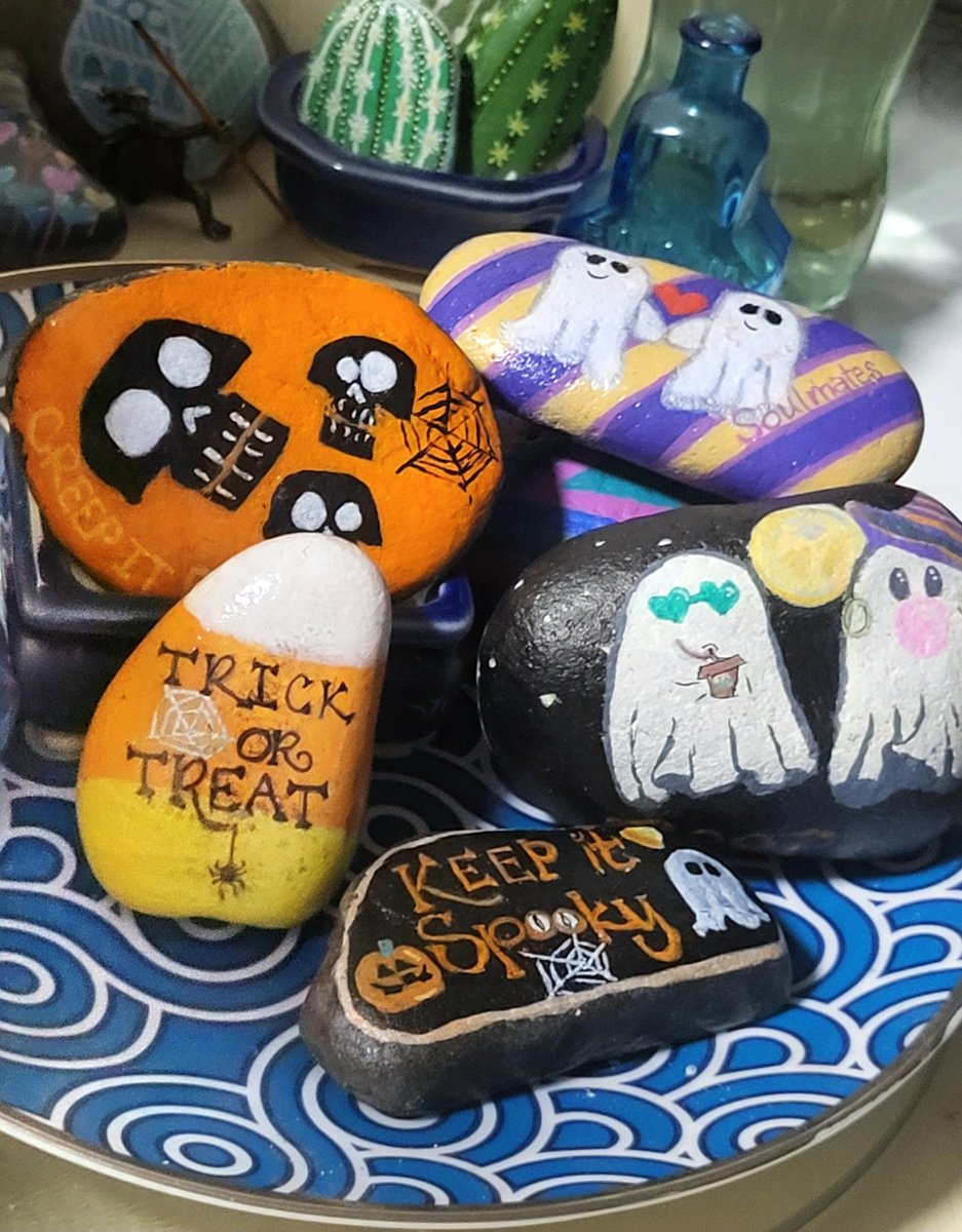 Halloween rock art arranged on a decorative tray, with skulls, candy corn, ghost couples, and Keep it Spooky lettering