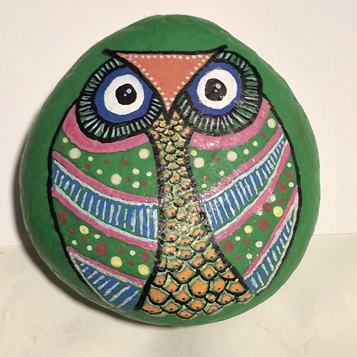 Green owl rock art with colorful hand-painted patterns, designed and painted by Jung