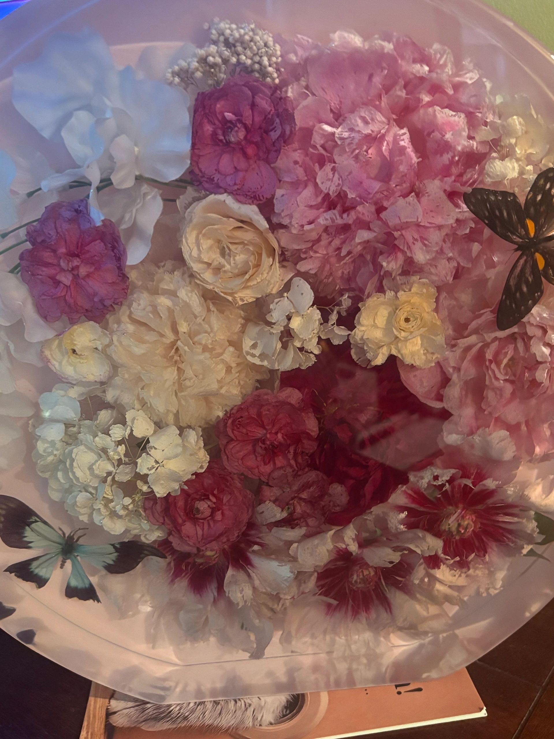 A real floral keepsake with pink, white, and burgundy flowers