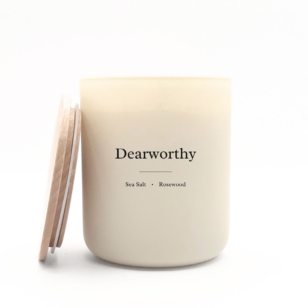 A lit candle creating a warm, quiet atmosphere for reading