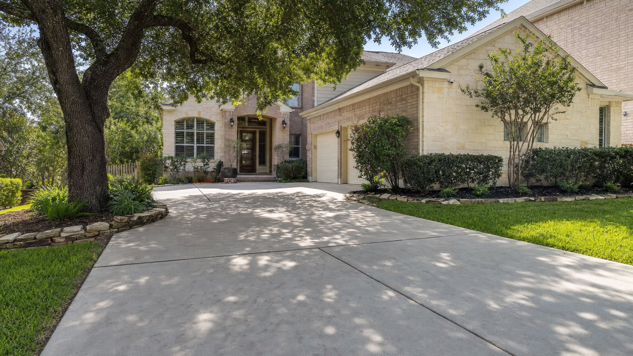 Clean residential driveway and front walk at a San Antonio home