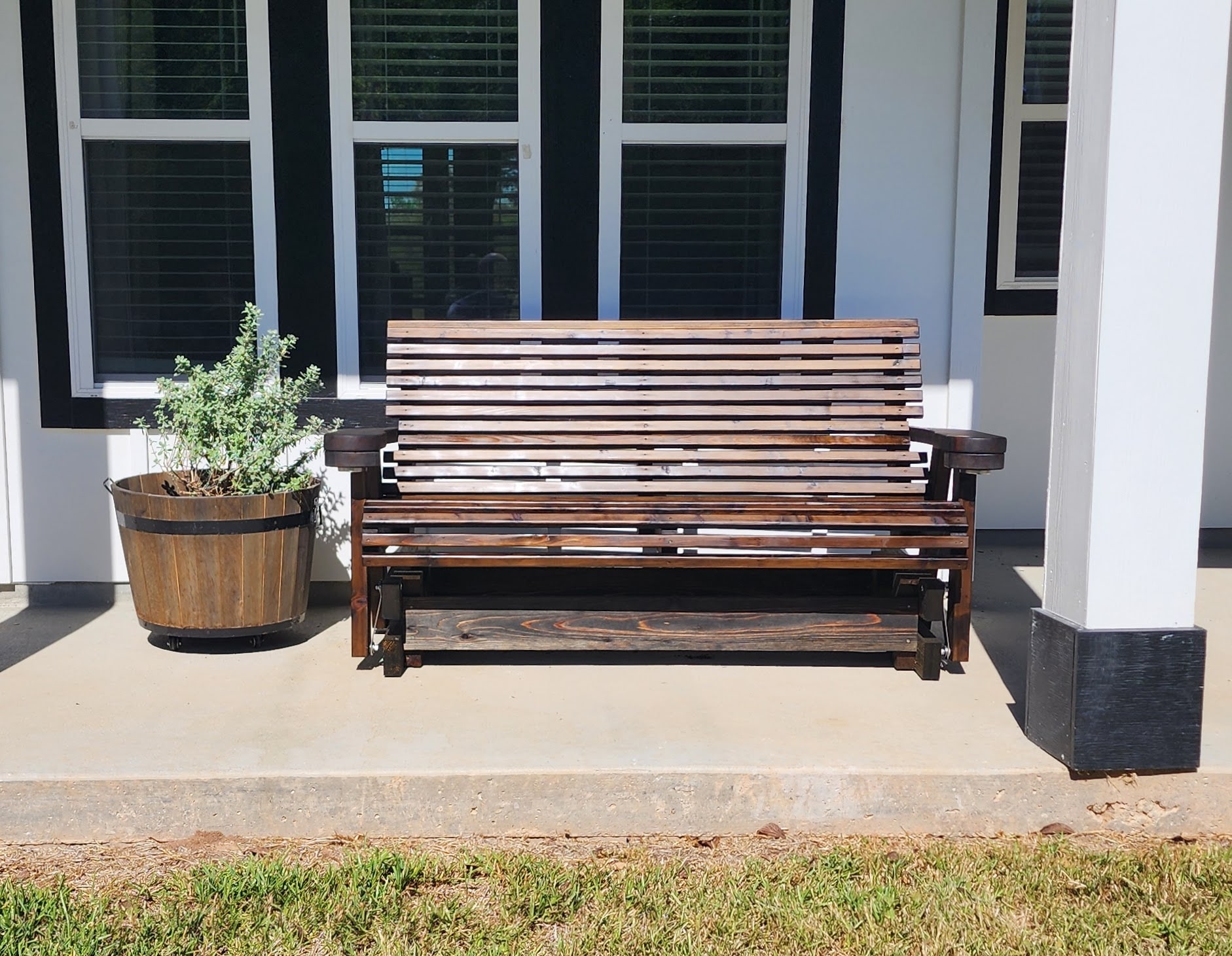 Vintage porch glider with cup holders.
