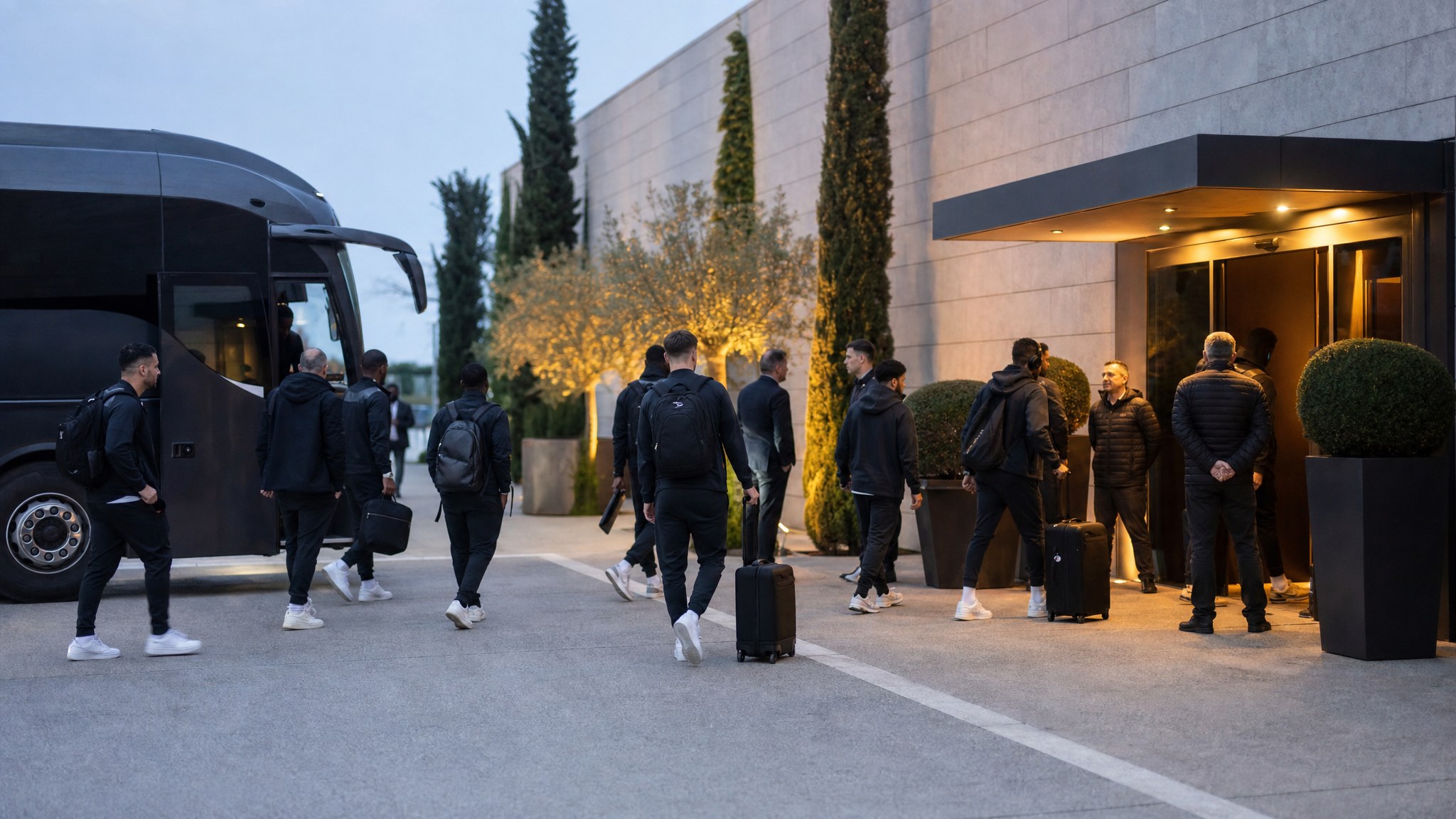 Professional football team arriving at a hotel from a team coach