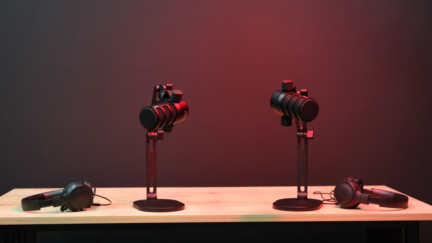 Two microphones and headphones prepared for a podcast conversation