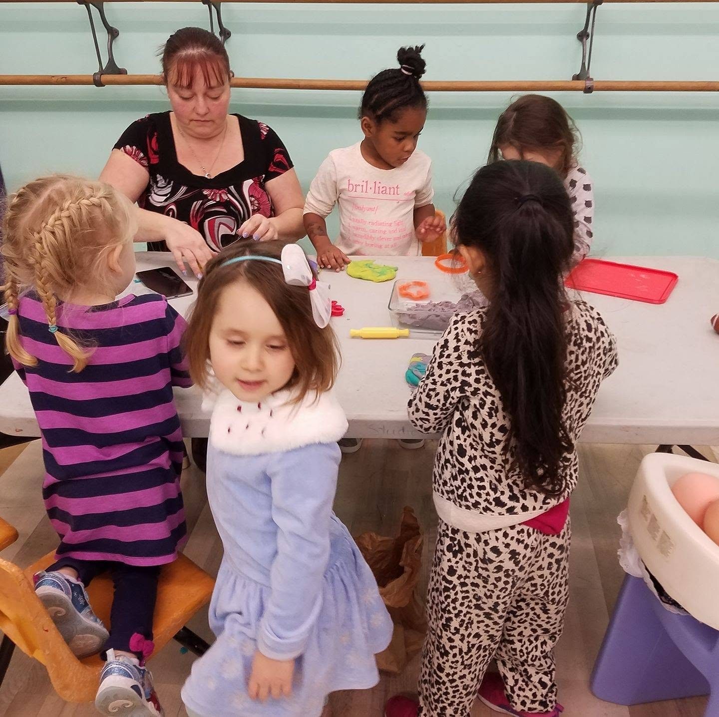 A small group of preschool children creating together