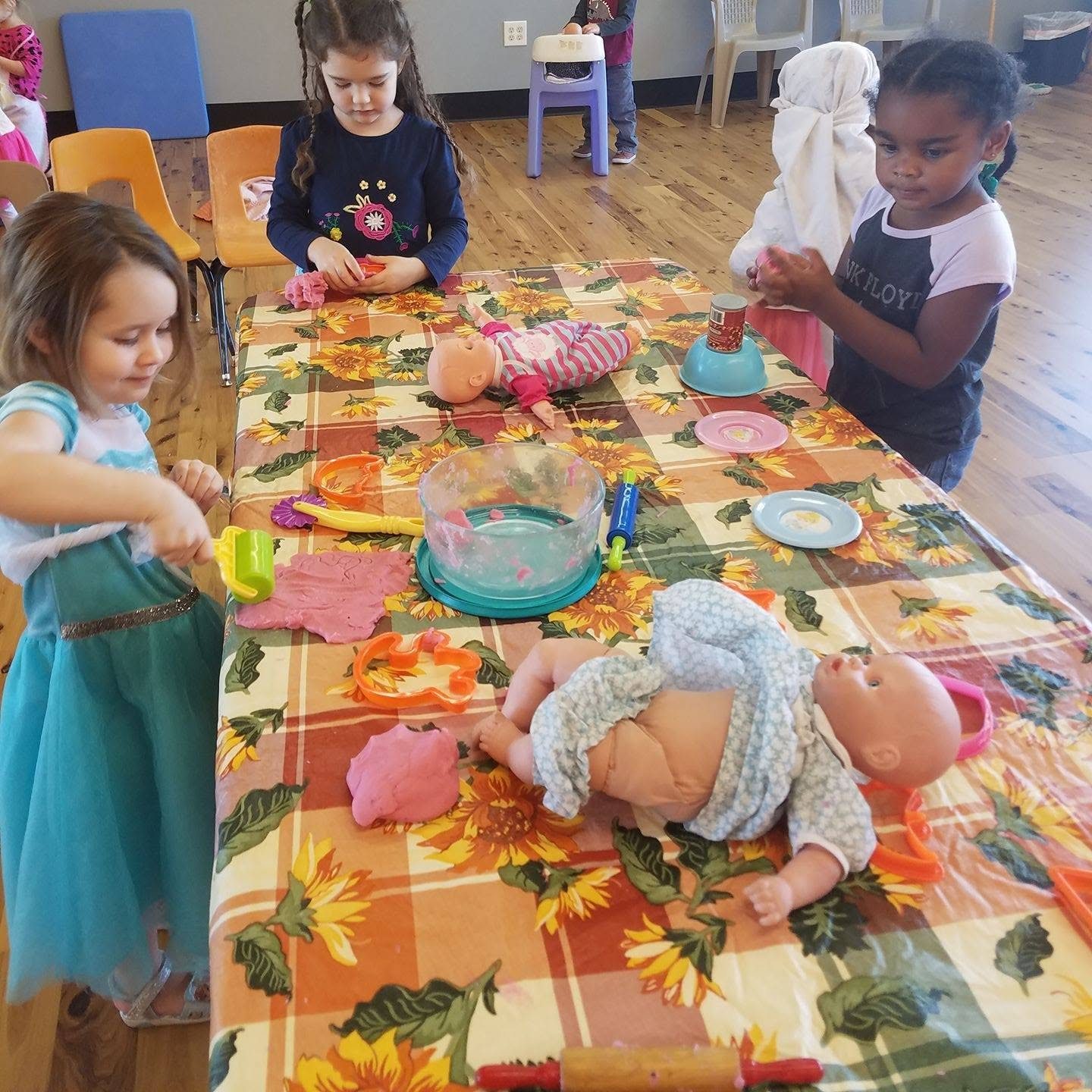 Children enjoying creative pretend play at a classroom table