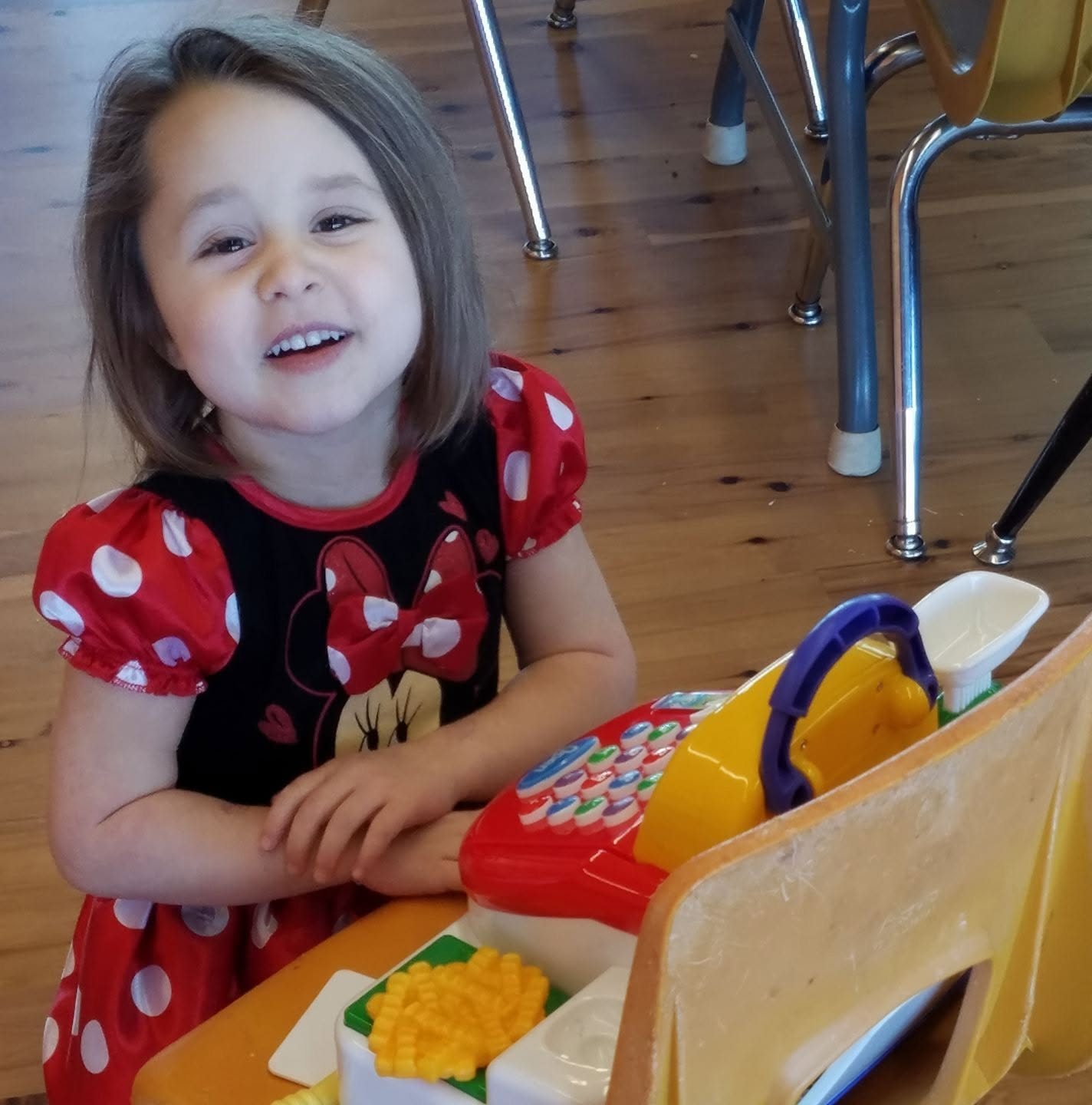 Children smiling during hands-on letter learning