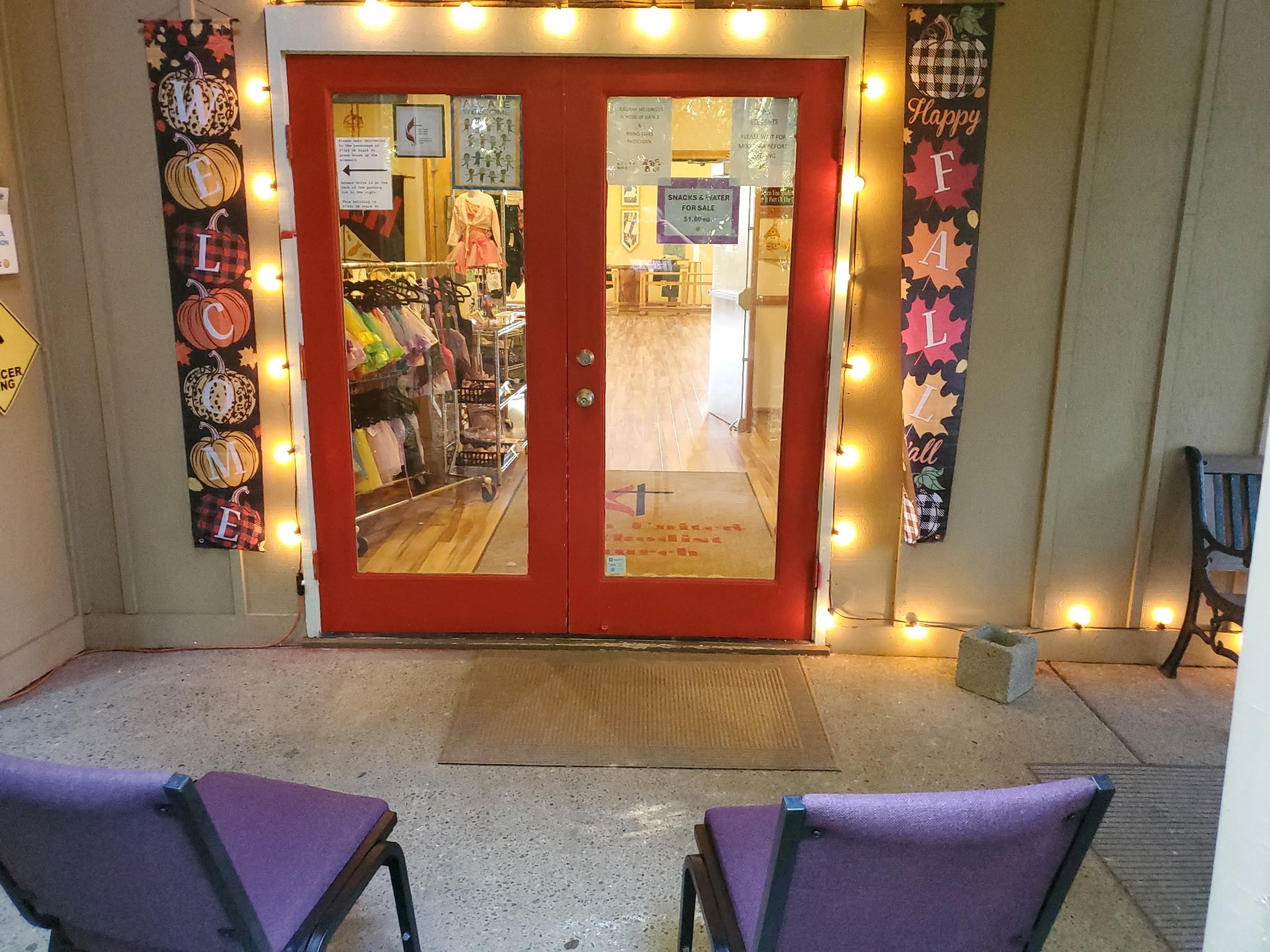 Warmly lit front entrance with fall decorations at Deborah’s Rising Stars Preschool