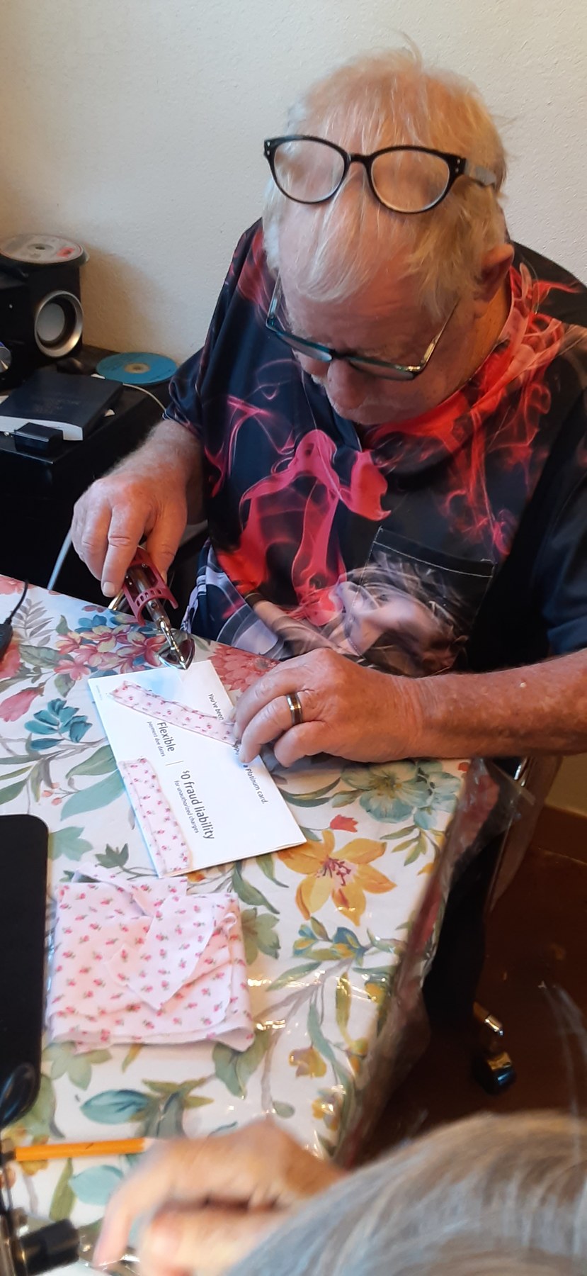 Family member cutting fabric at the craft table