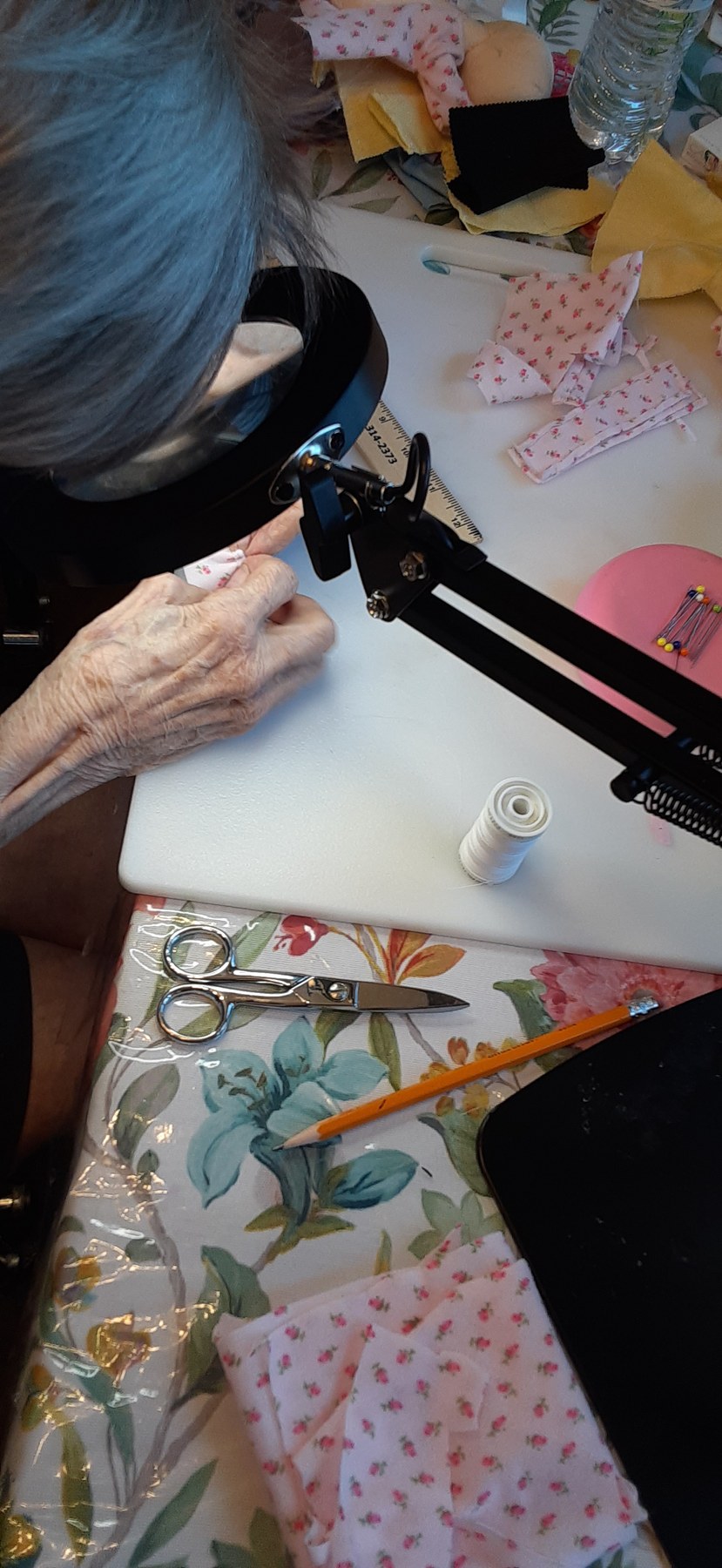 Grandmother carefully working on a handmade fabric piece