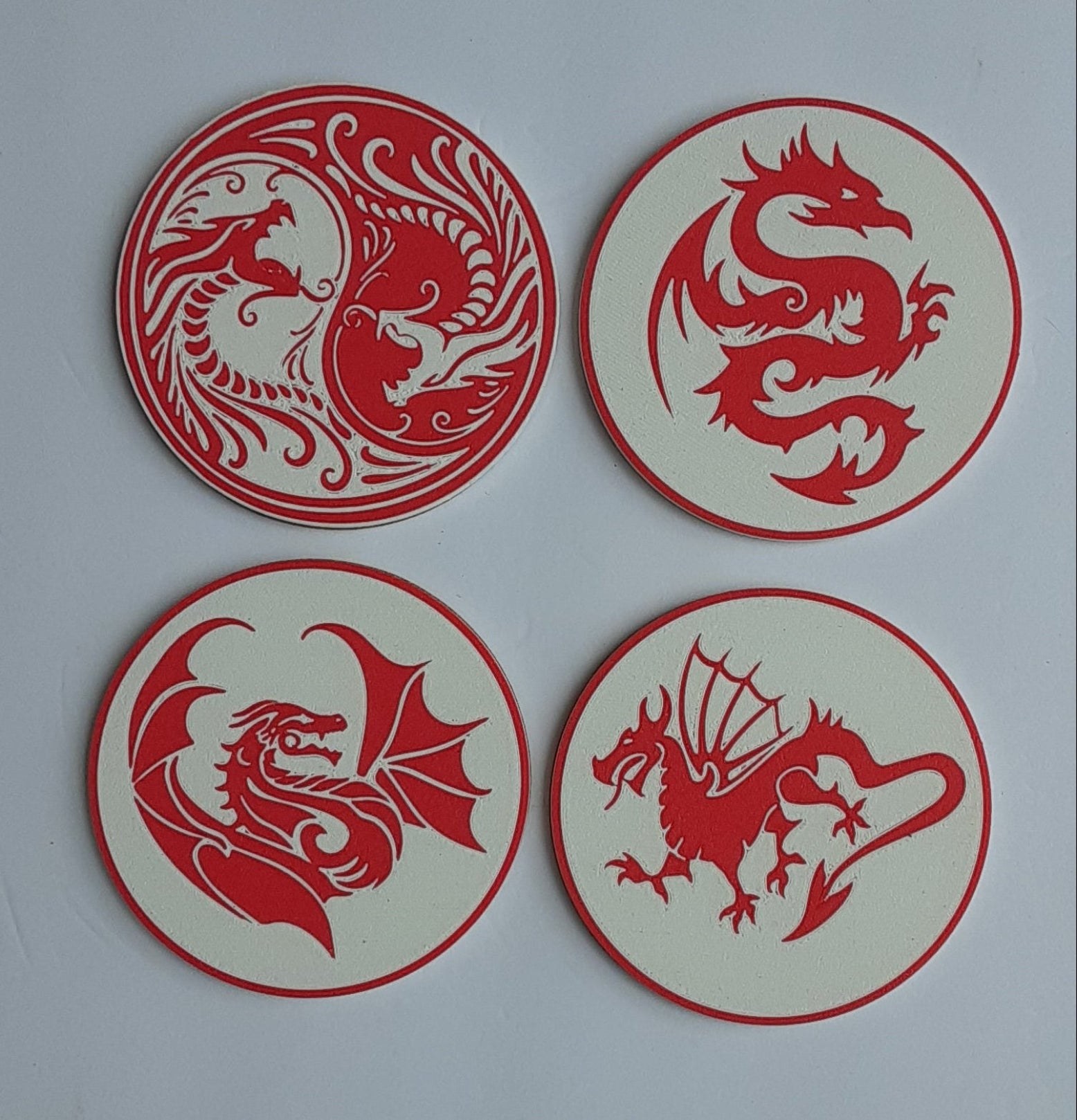 A set of four handmade 3D-printed dragon coasters for a fantasy fan