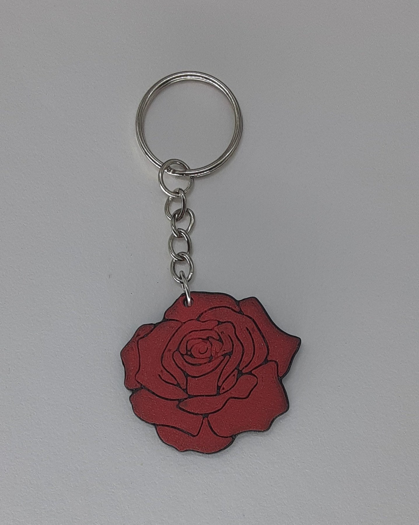 A handmade red rose 3D-printed keychain, sized for a thoughtful stocking stuffer