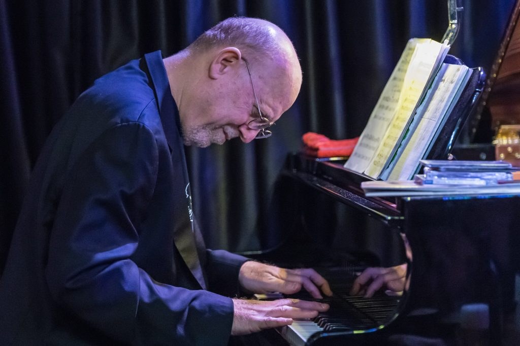 Michael Jefry Stevens playing piano on stage