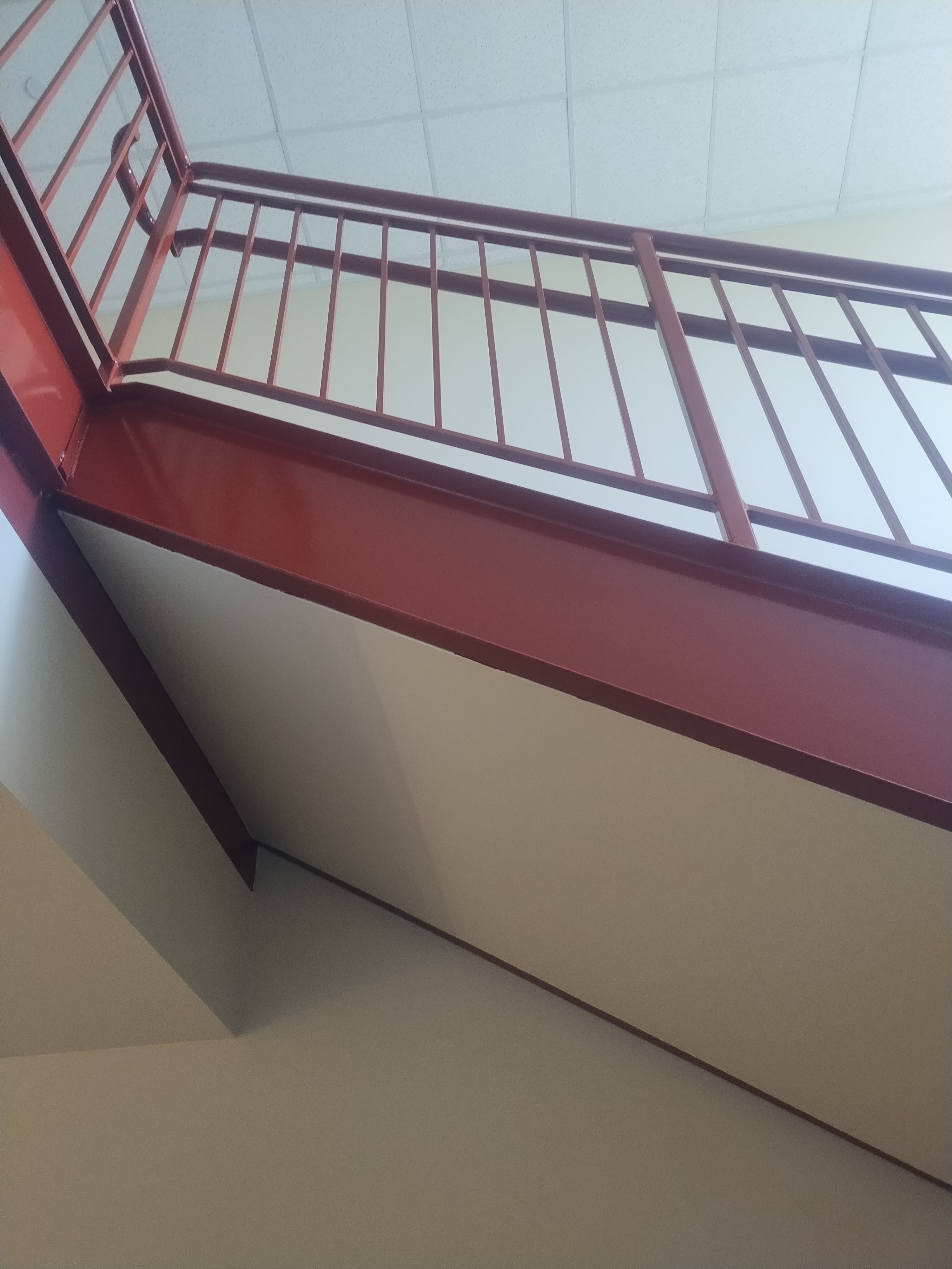 Fresh red finish on a commercial stairway railing