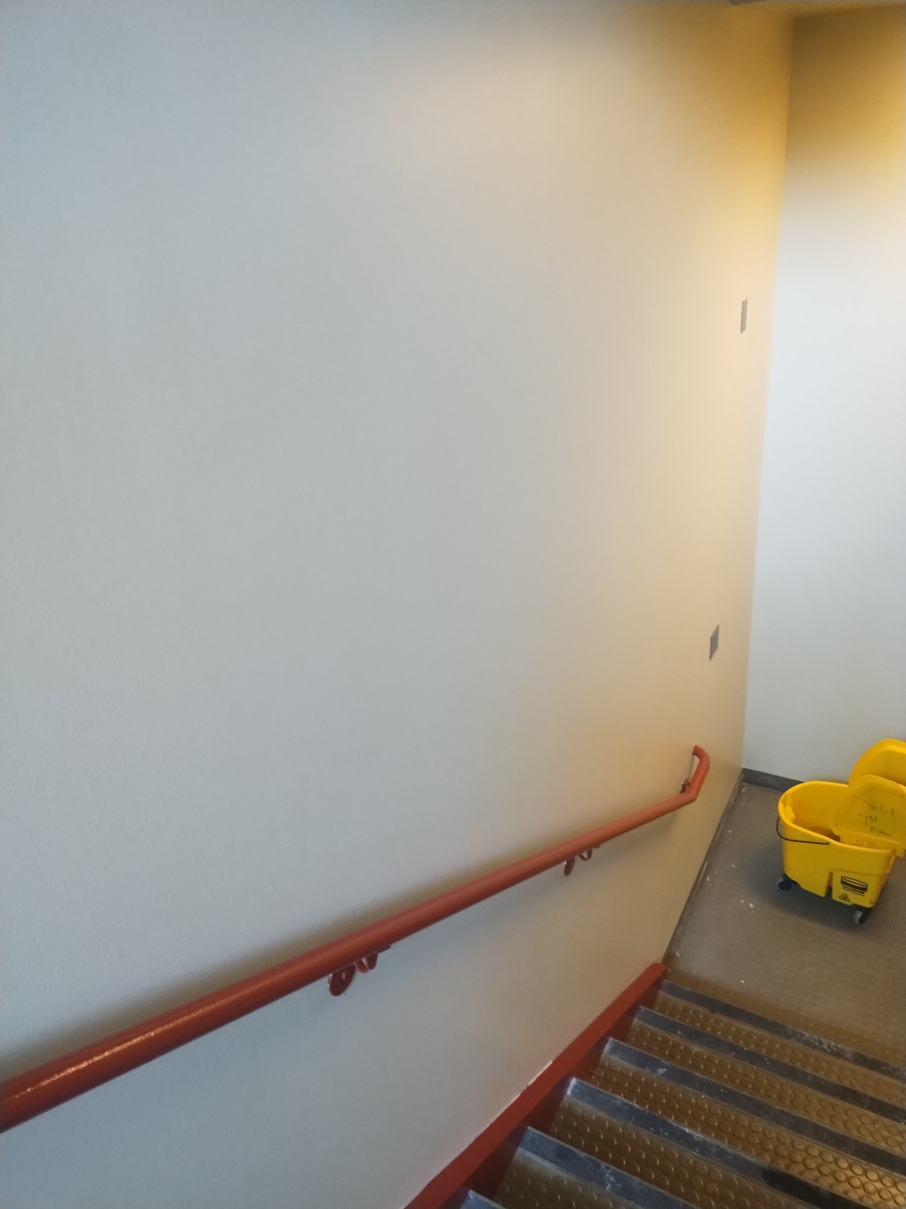 Commercial stairway with finished walls and railings