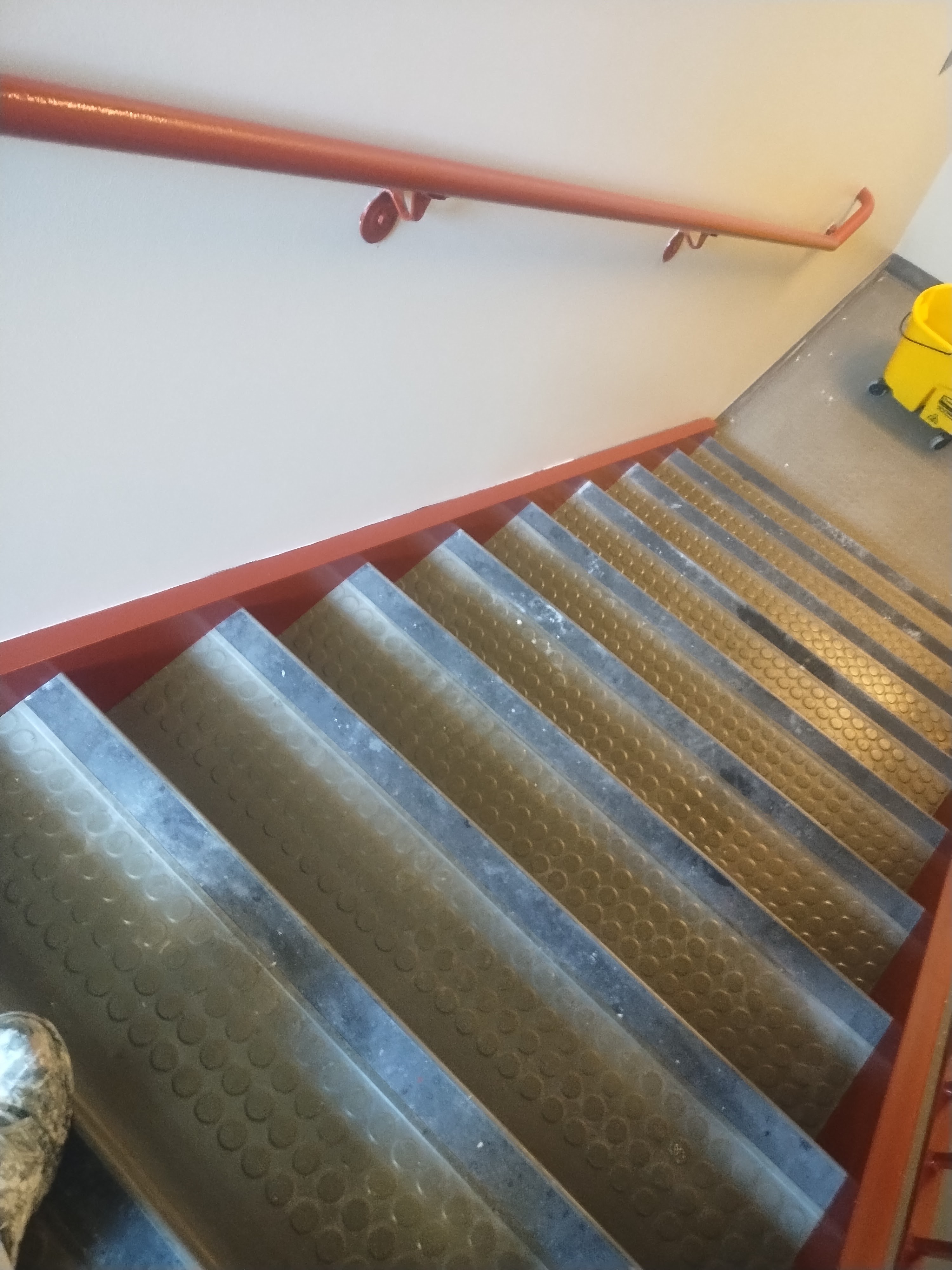 Clean commercial stairwell wall and handrail finish
