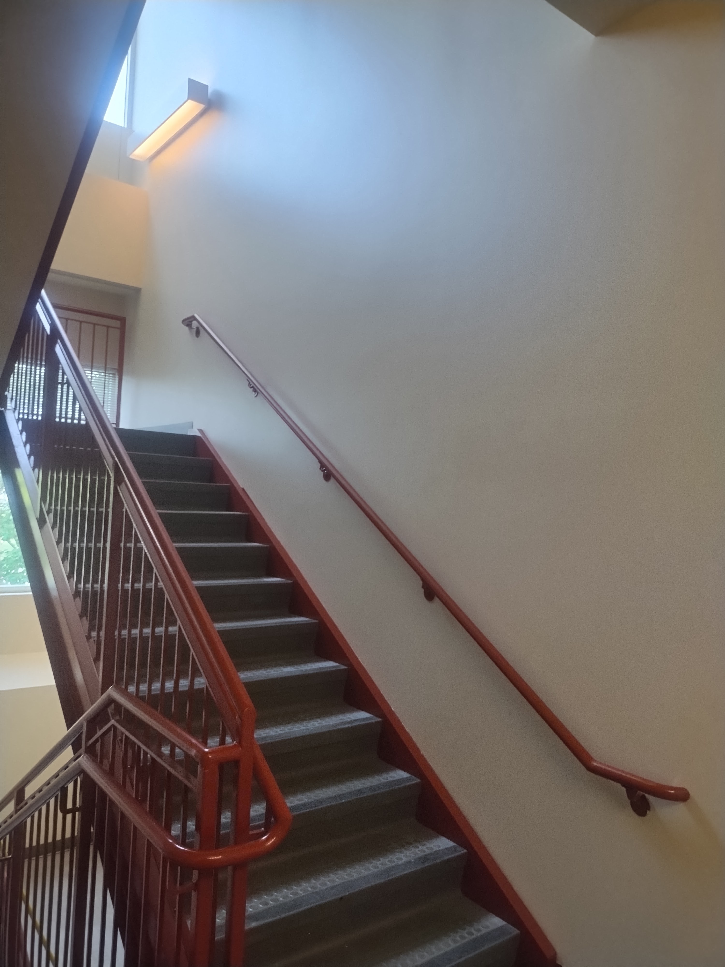 Red stair railing with a clean commercial wall finish