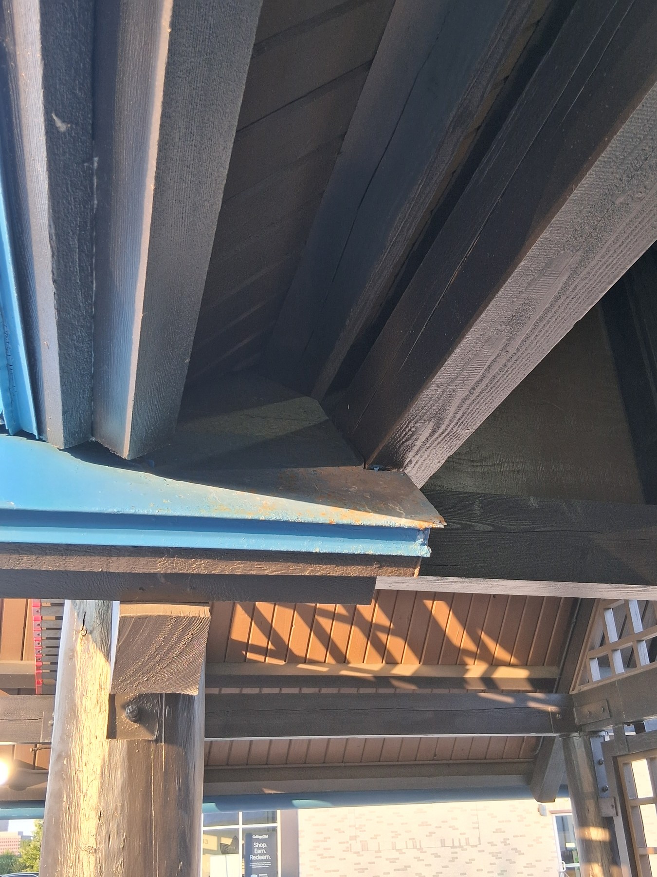 Detailed finish work under a commercial roof overhang