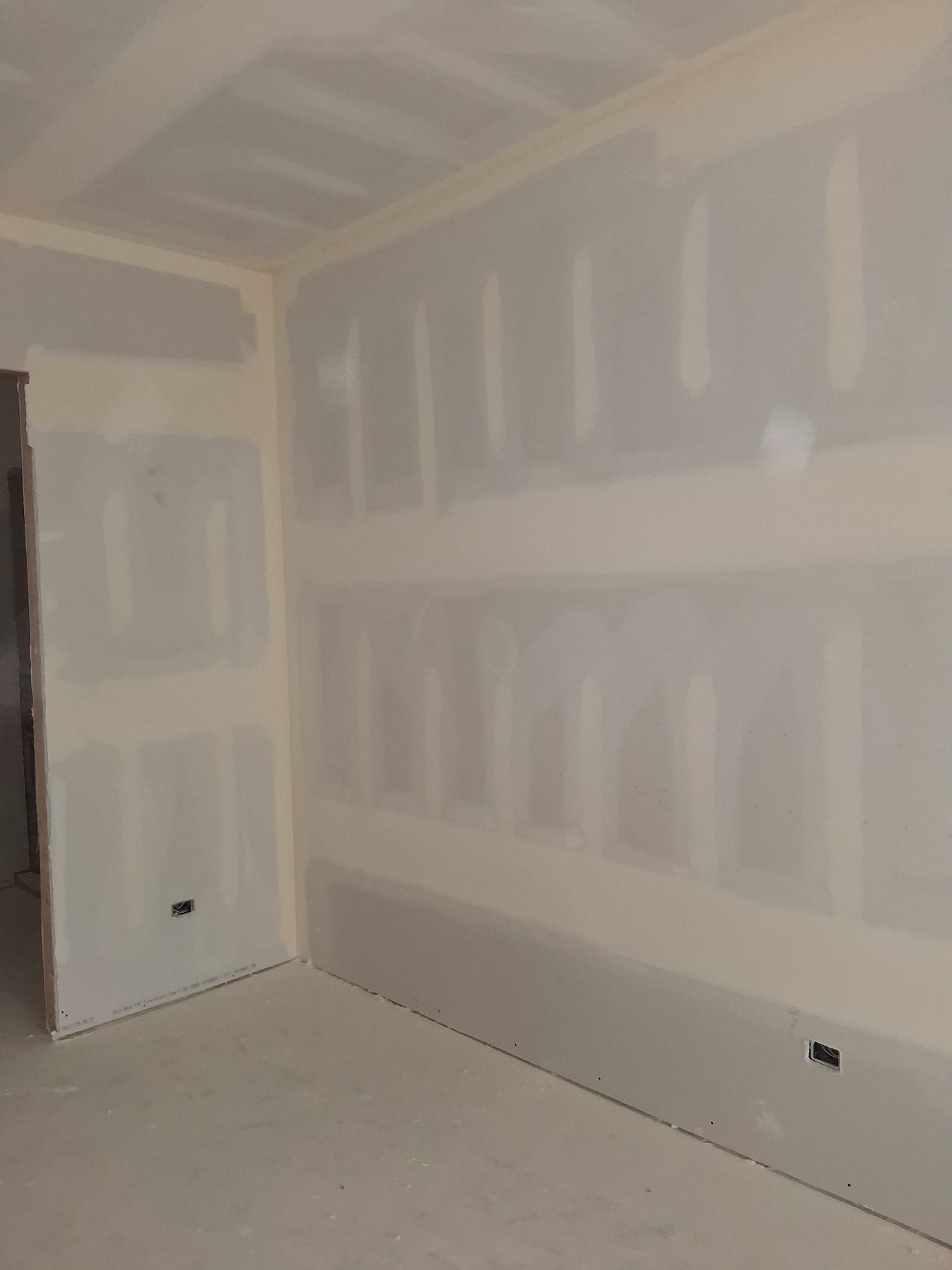 Taped and finished drywall around a room corner