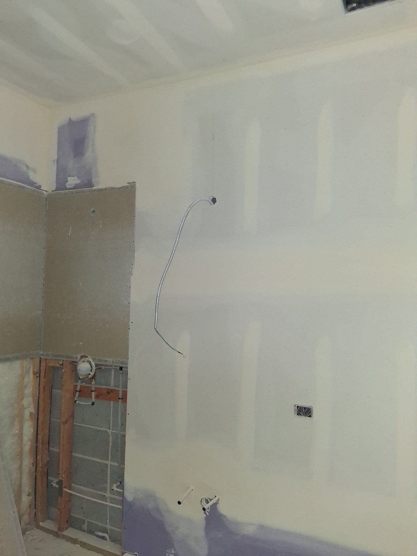 Drywall finishing in an in-progress bathroom