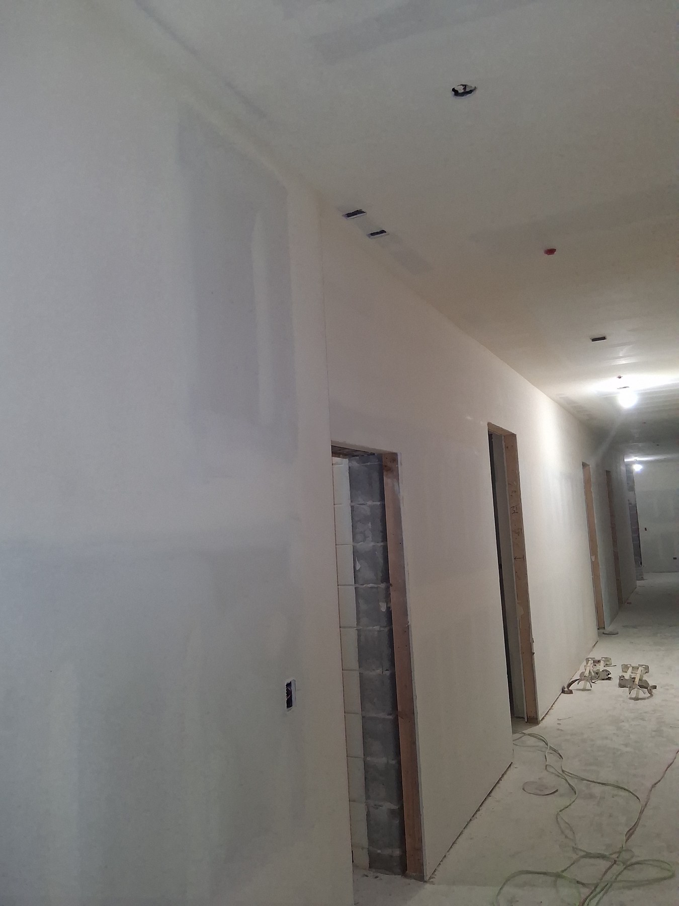 Finished drywall along a new home's hallway