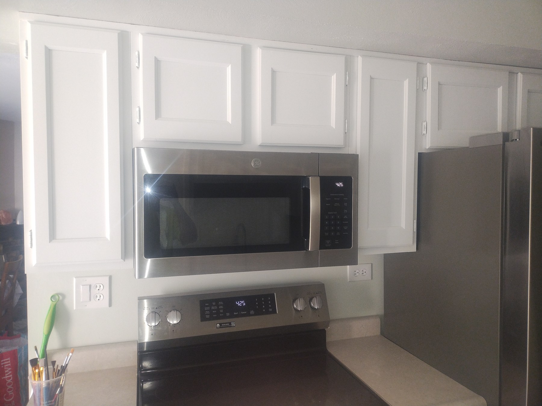 White kitchen cabinets with microwave and range
