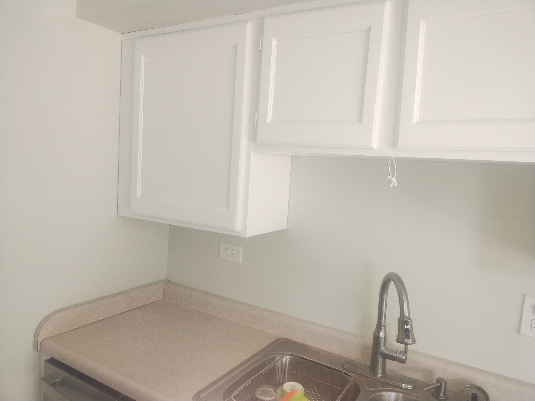 Refinished sink cabinet with dark hardware
