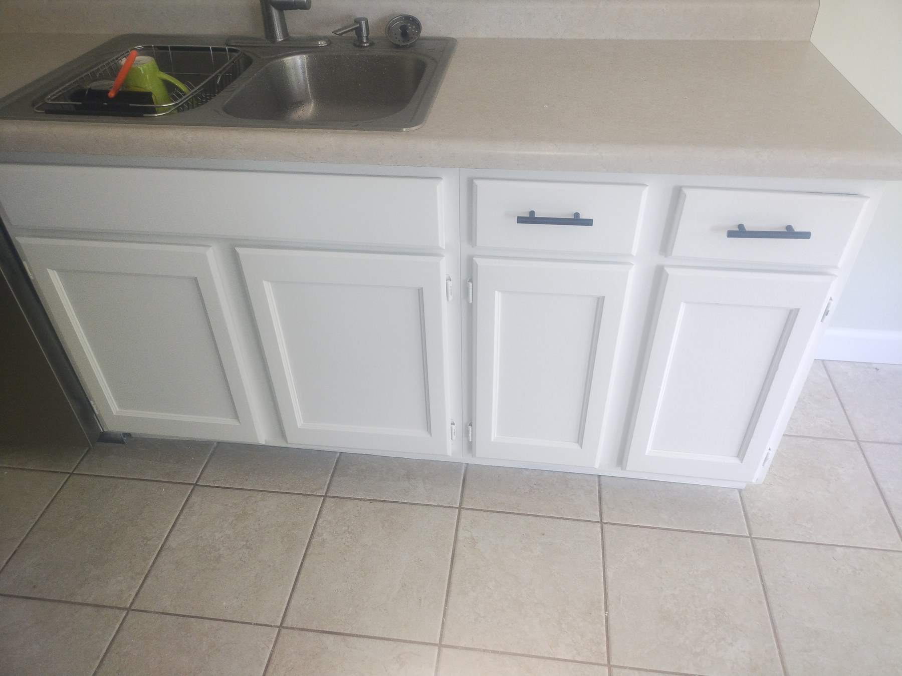 White lower cabinets and sink base