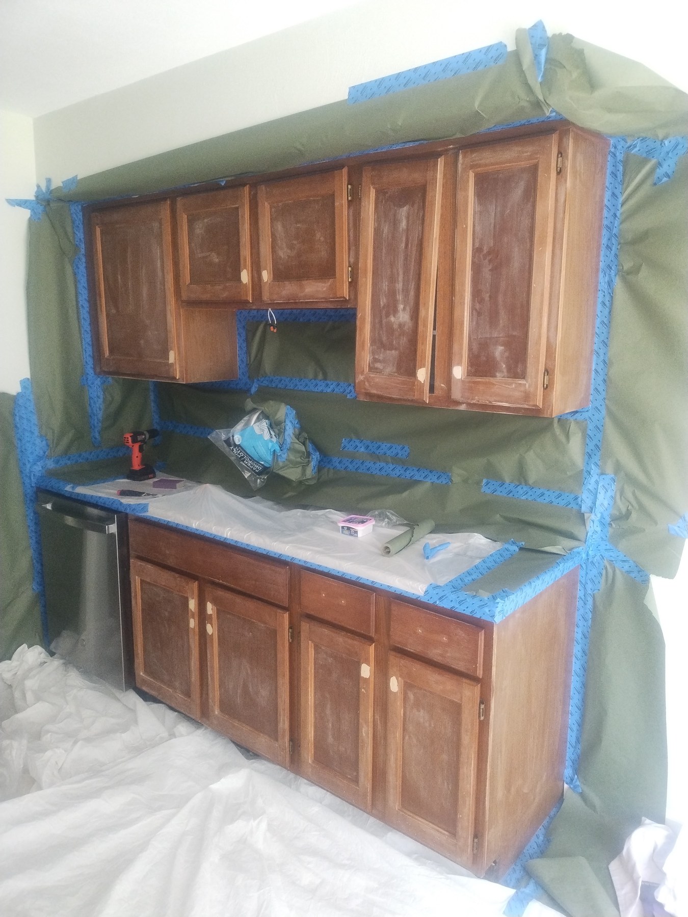 Brown kitchen cabinets prepared for refinishing
