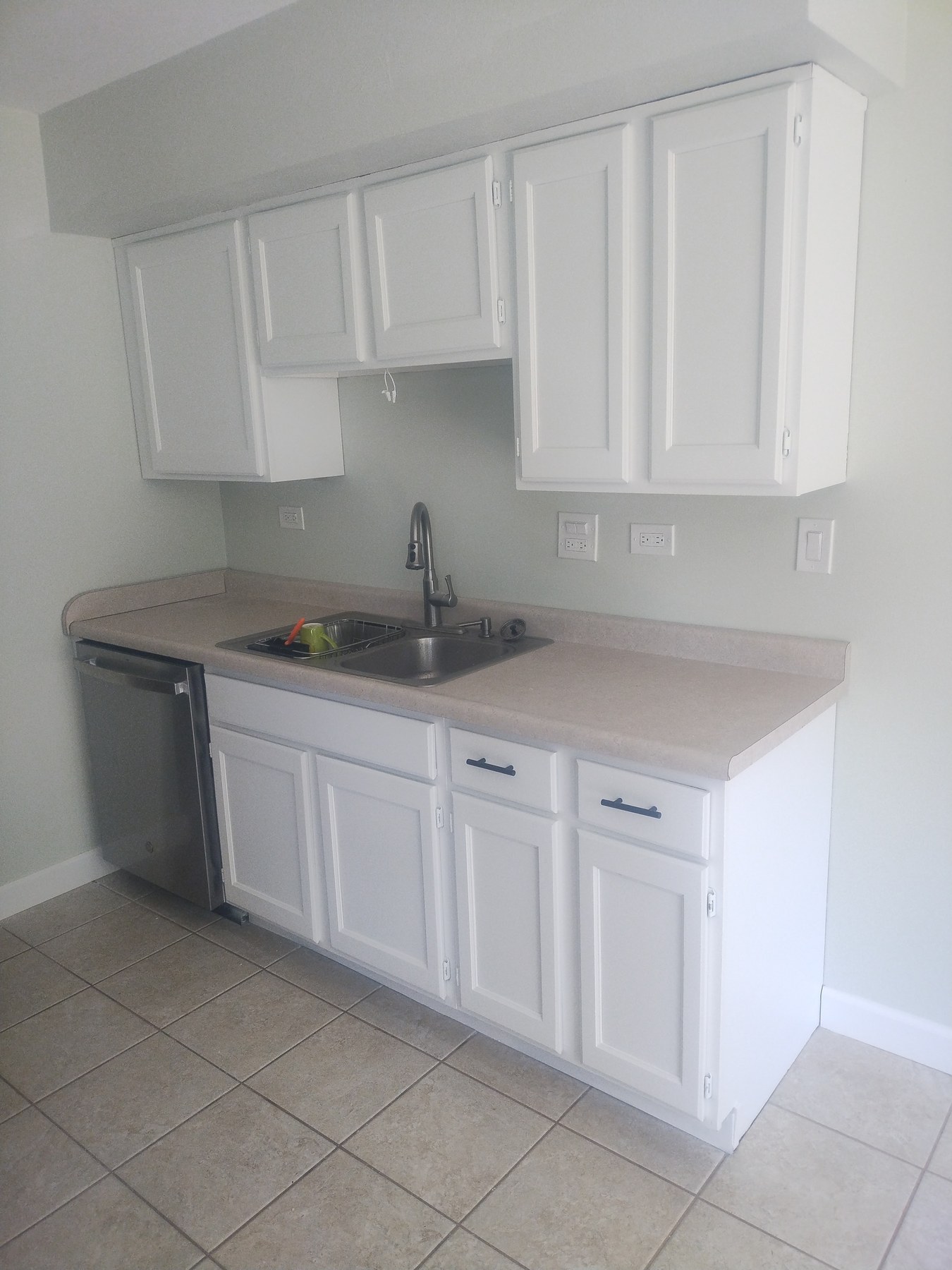 Completed white cabinets at the kitchen sink