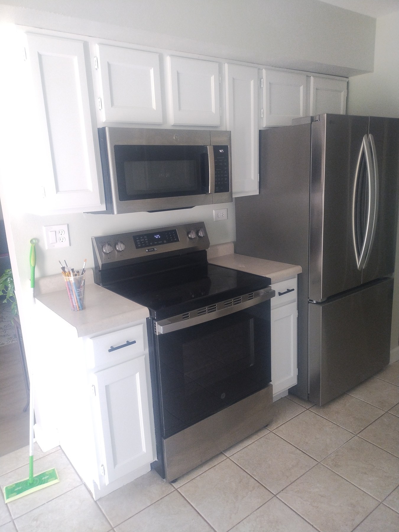 Refinished white cabinets near the kitchen range