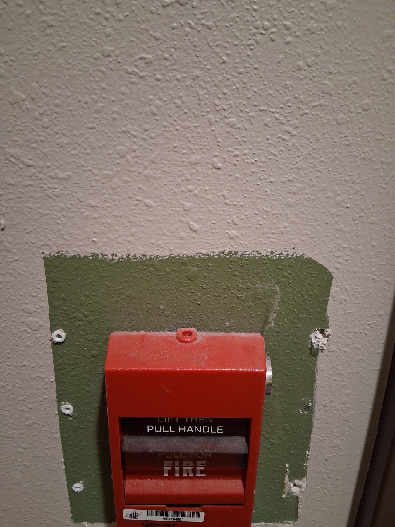 Commercial wall repair around a fire alarm