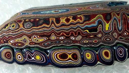 Fordite cross-section showing rings of automotive paint