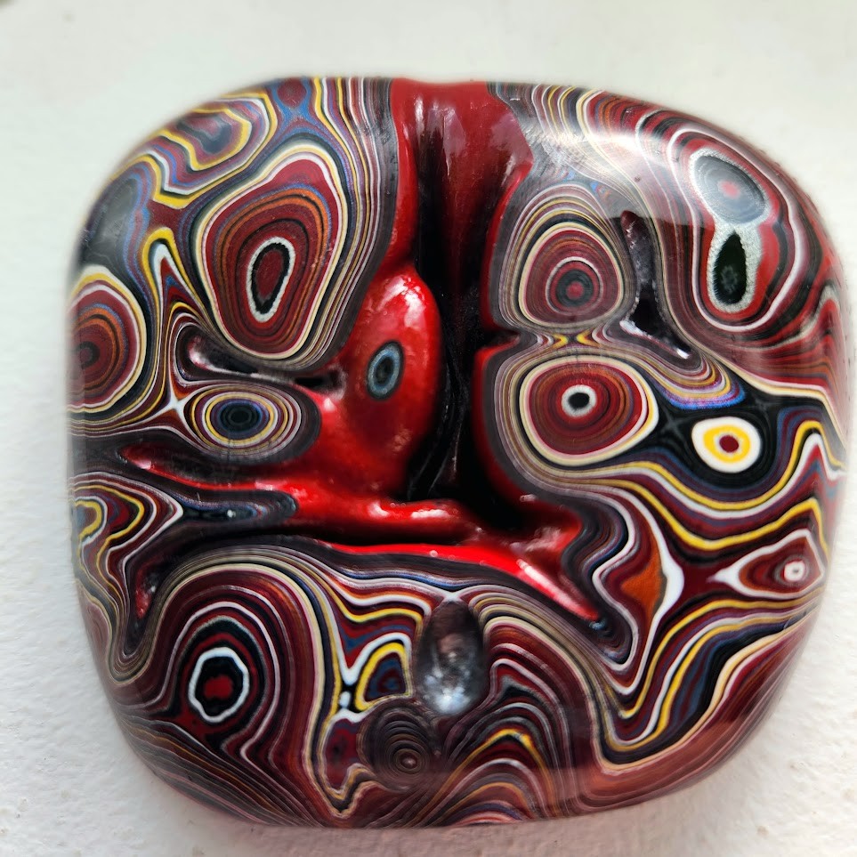 Hand-cut Northern Lights Fordite cabochon