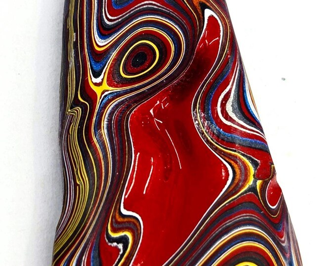 Red, blue, yellow, and white Fordite cabochon